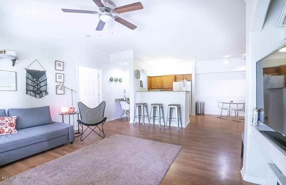 8550 Touchton Road, Unit 218 Jacksonville, FL 32216 - Photo 4 of 29 a living room with furniture and a flat screen tv