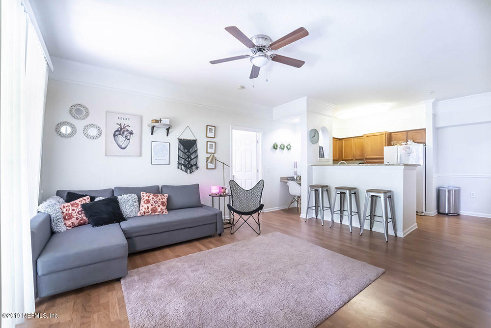 8550 Touchton Road, Unit 218 Jacksonville, FL 32216 - Photo 5 of 29 a living room with furniture wooden floor and a window