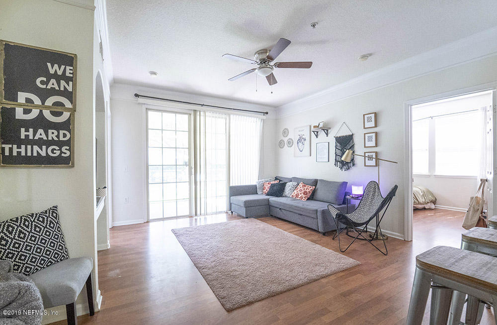 8550 Touchton Road, Unit 218 Jacksonville, FL 32216 - Photo 6 of 29 a living room with furniture and a window