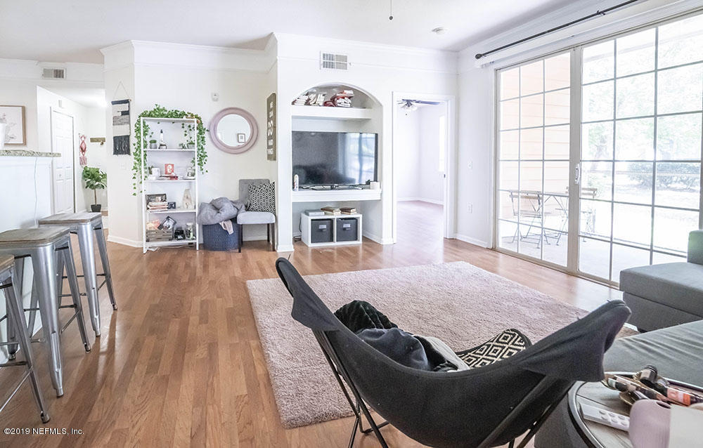 8550 Touchton Road, Unit 218 Jacksonville, FL 32216 - Photo 7 of 29 a living room with furniture and flat screen tv