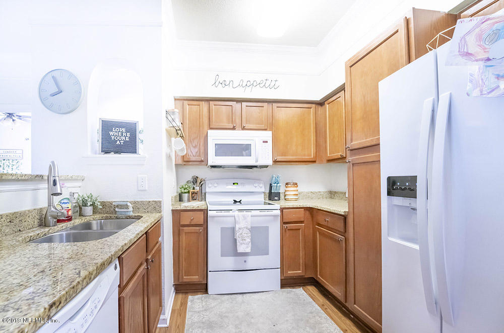 8550 Touchton Road, Unit 218 Jacksonville, FL 32216 - Photo 8 of 29 a kitchen with a sink stove and refrigerator