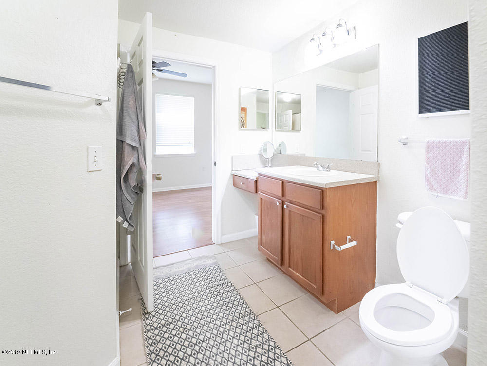 8550 Touchton Road, Unit 218 Jacksonville, FL 32216 - Photo 9 of 29 a bathroom with a sink a toilet and shower
