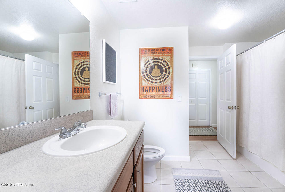 8550 Touchton Road, Unit 218 Jacksonville, FL 32216 - Photo 10 of 29 a bathroom with a sink a toilet and shower