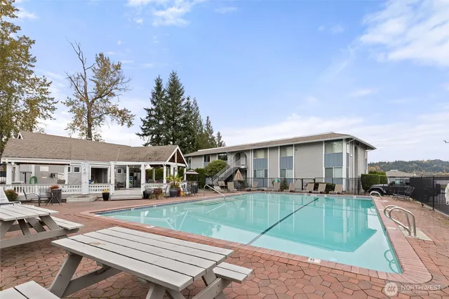 a view of a house with backyard sitting area and sitting area