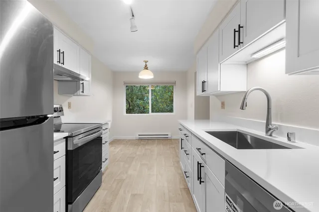 a kitchen with a sink stove and cabinets