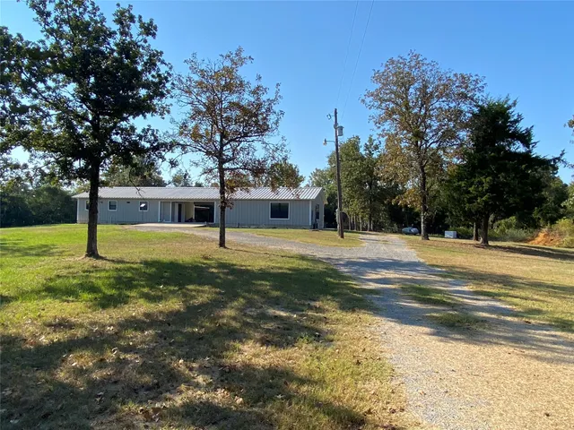 a view of yard with swimming pool and trees