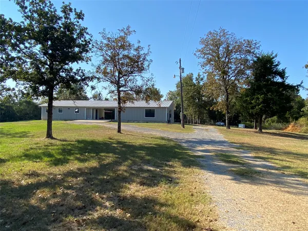 a view of yard with swimming pool and trees