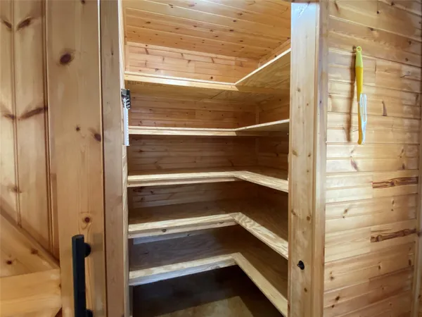 a view of walk in closet and empty room