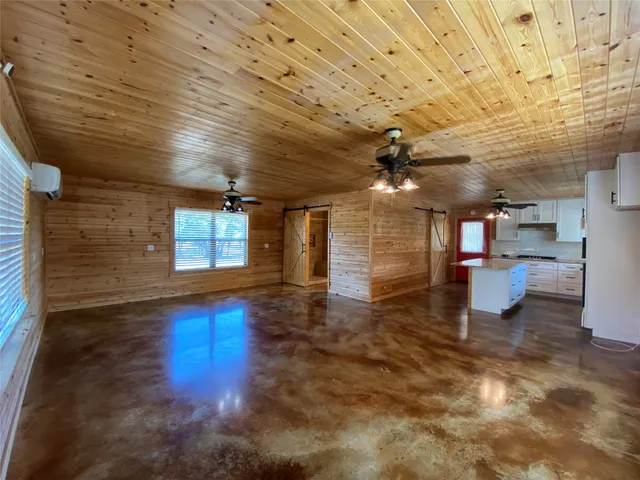 a view of a room with wooden floors