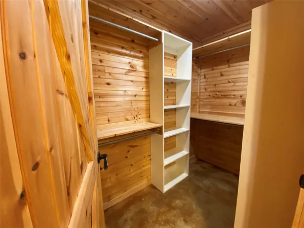 an empty room with windows and closet