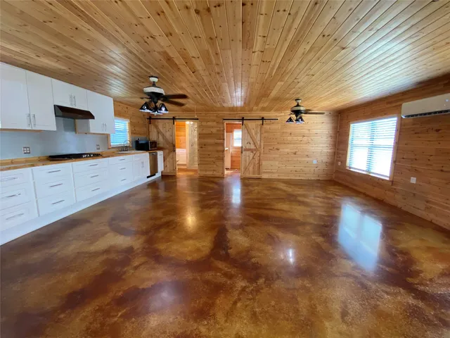 a large room with lots of counter space and wooden floor