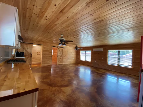 a view of a room with lots of wooden furniture