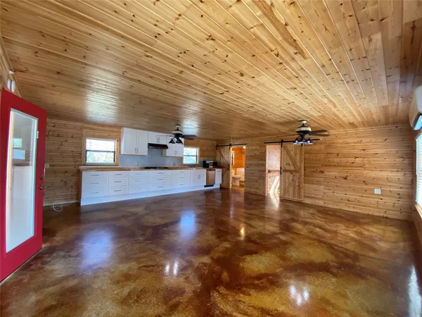 a large kitchen with stainless steel appliances granite countertop a sink and cabinets