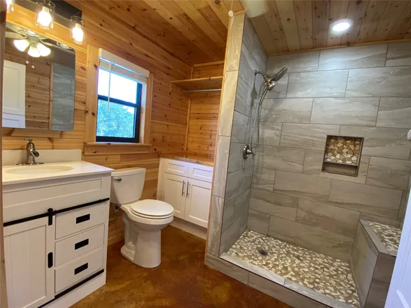 a bathroom with a shower and a toilet