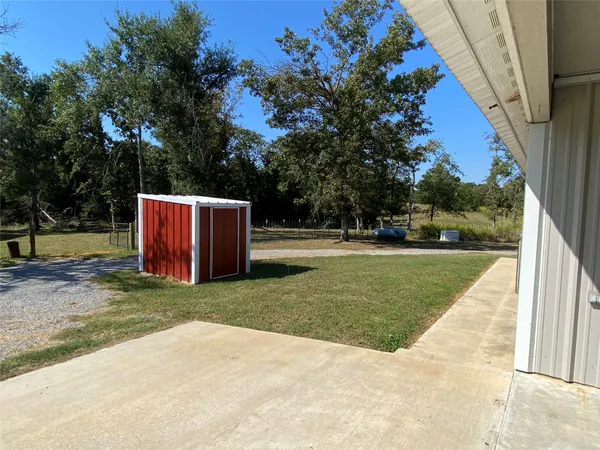 a view of backyard with table and chairs and a slide