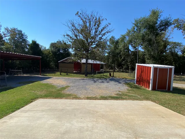 a view of backyard with table and chairs and a slide