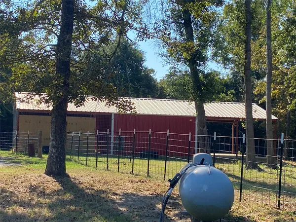a view of a house with a backyard and a tree