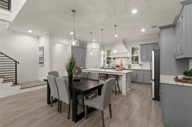 a large kitchen with a table and chairs
