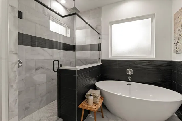 a bathroom with a bathtub and shower