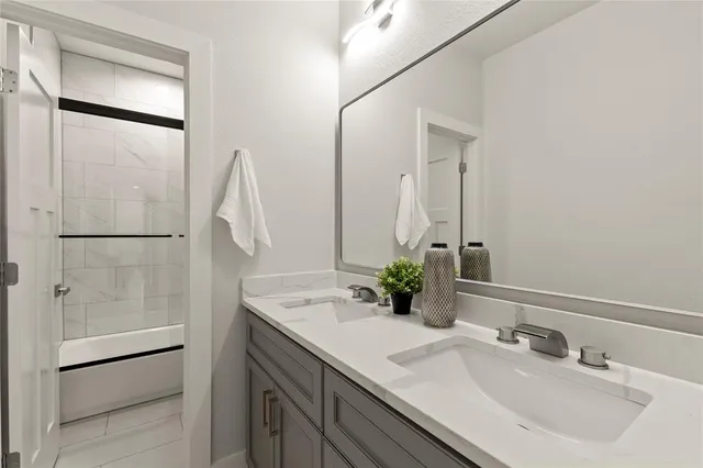 a bathroom with a double vanity sink and a mirror