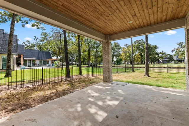 a view of a house with backyard and a trees