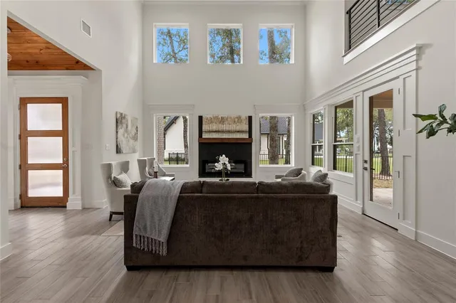 a living room with fireplace furniture and a wooden floor