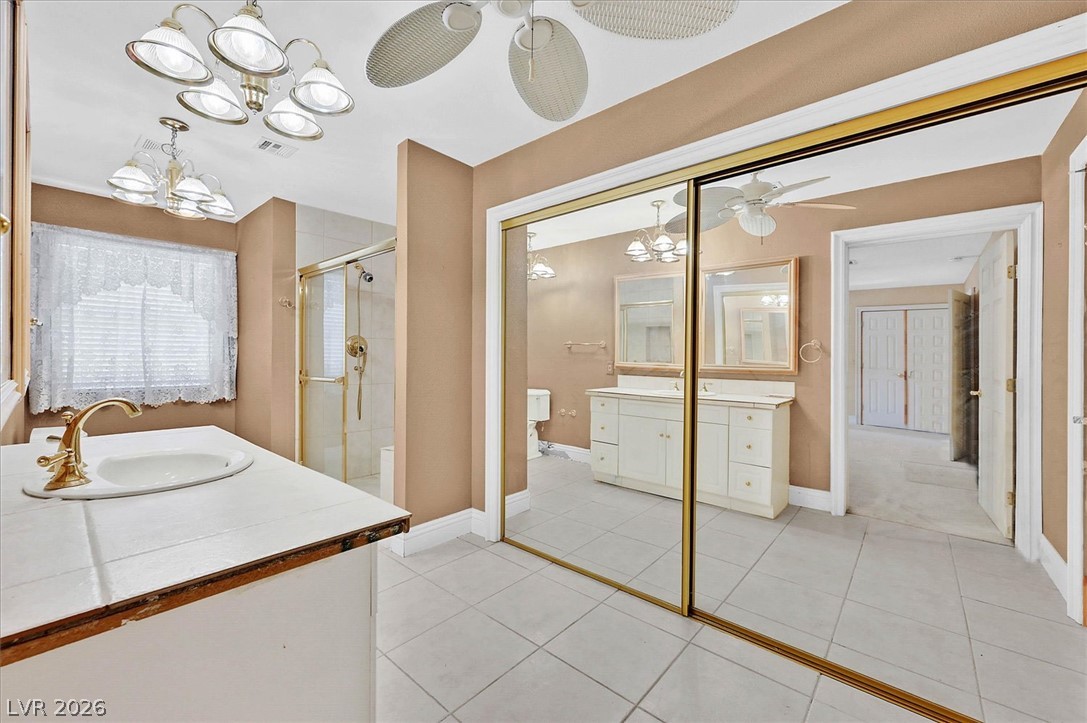 3618 Fieldcrest Road Las Vegas, NV 89121 - Photo 21 of 36 Functional bathroom offering a tiled vanity, mirror-fronted storage, and a separate shower enclosure.