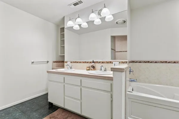 a bathroom with a sink a vanity and mirror
