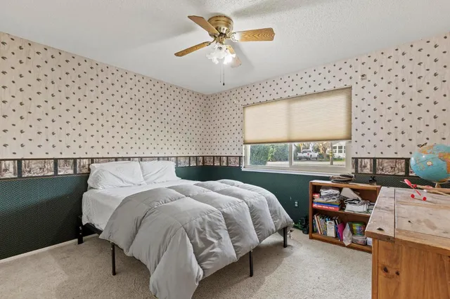 a bedroom with a bed and a chandelier