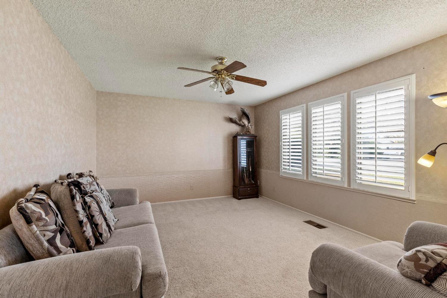 225 Elm Street Maxwell, CA 95955 - Photo 22 of 50 a living room with furniture and a ceiling fan