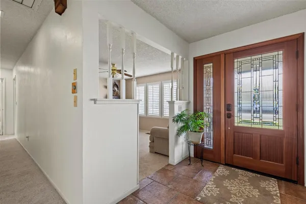 a view of an entryway with wooden floor and a livingroom view