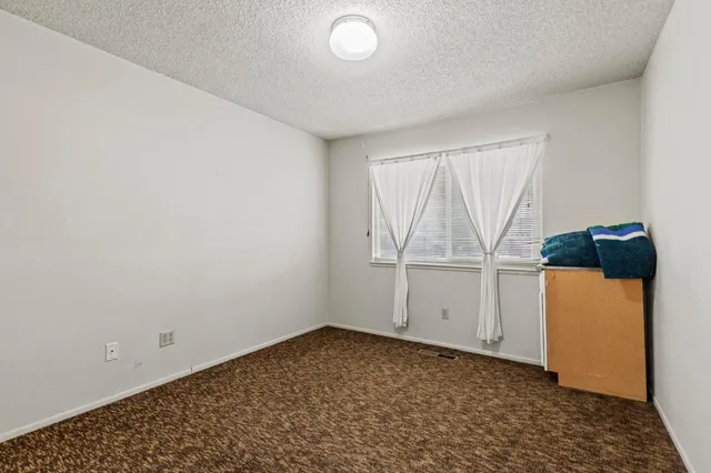 a view of storage and utility room with a window
