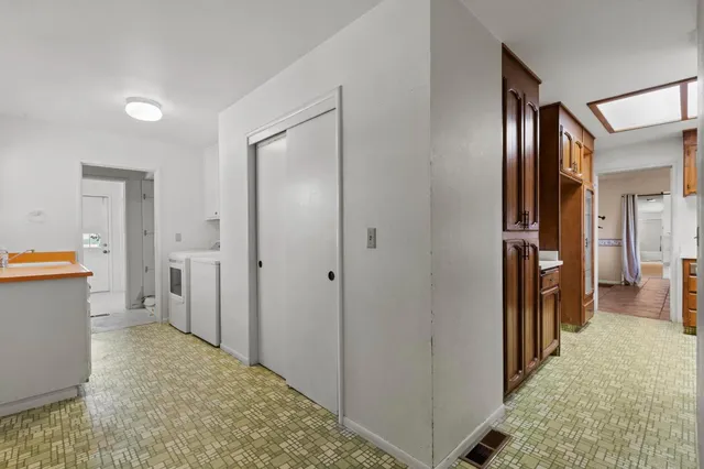 a view of hallway with livingroom and bathroom