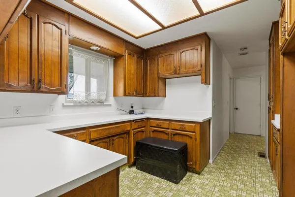 a kitchen with a sink stove and cabinets
