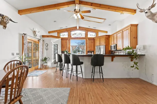 a view of a a dining room with furniture window and wooden floor