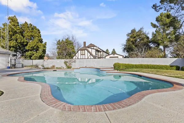 a view of a swimming pool with a yard