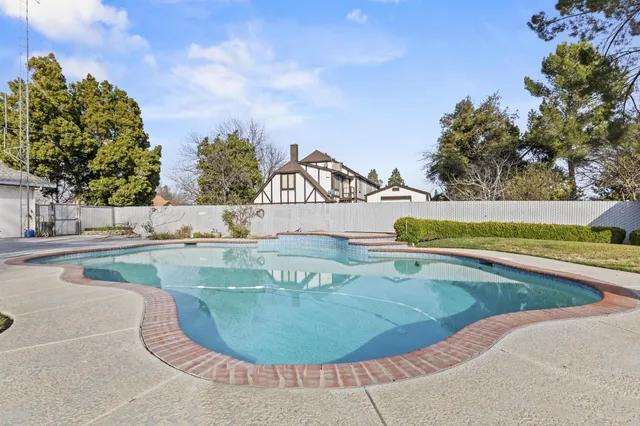 a view of a swimming pool with a yard