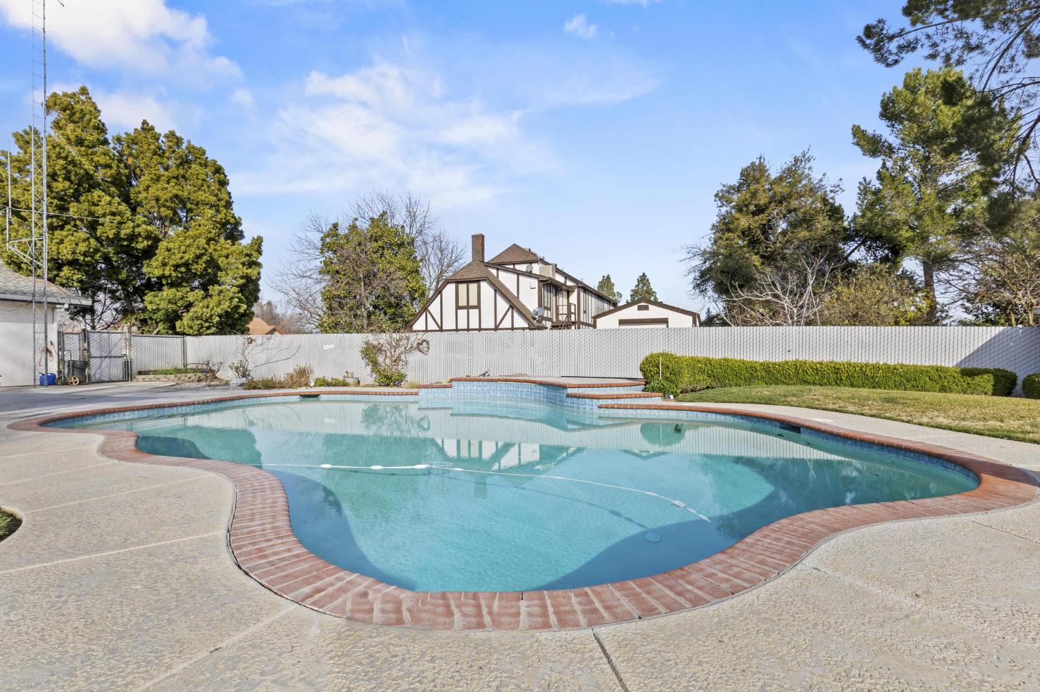 225 Elm Street Maxwell, CA 95955 - Photo 36 of 50 a view of a swimming pool with a yard