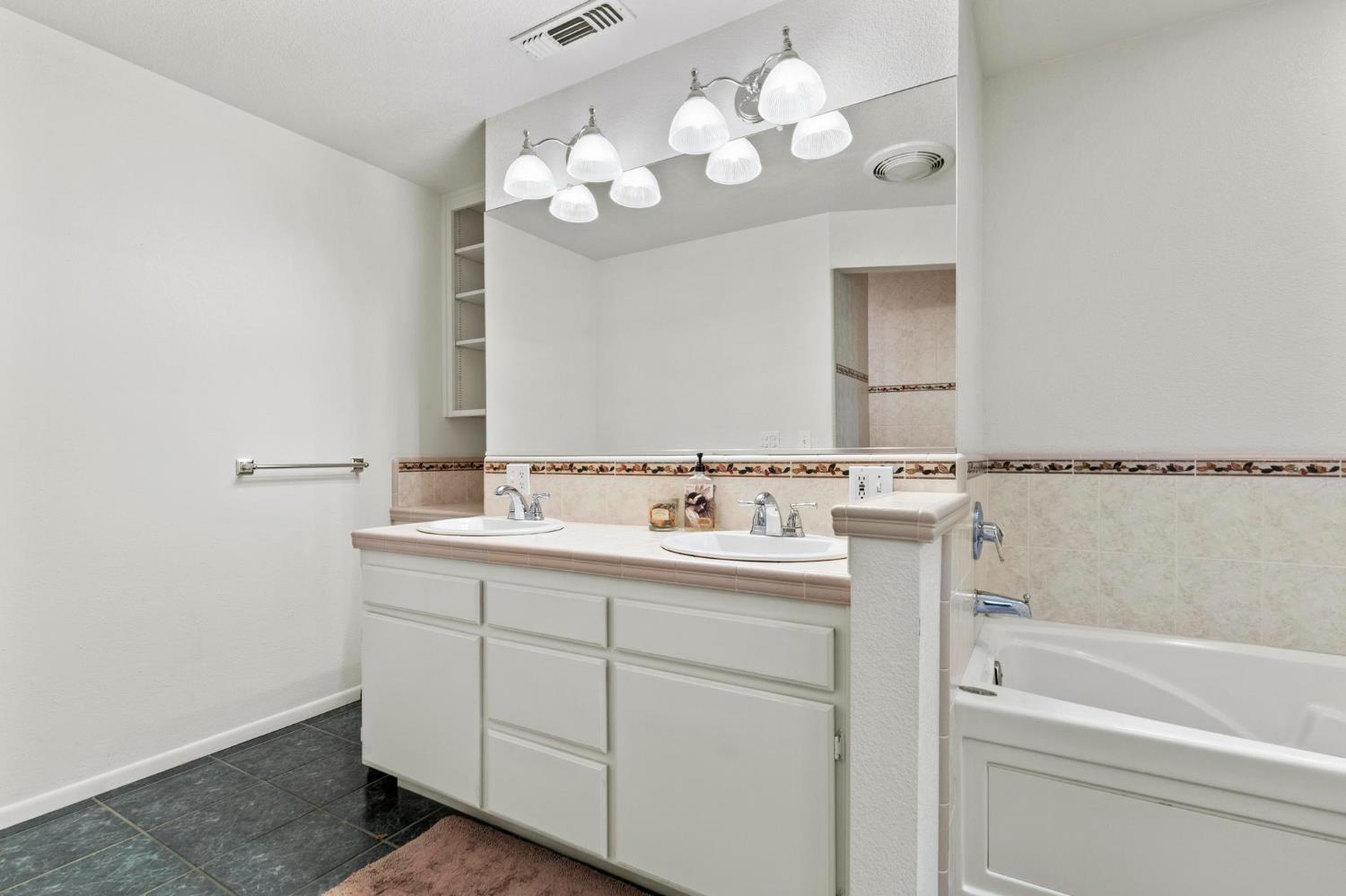 225 Elm Street Maxwell, CA 95955 - Photo 10 of 50 a bathroom with a sink a vanity and mirror