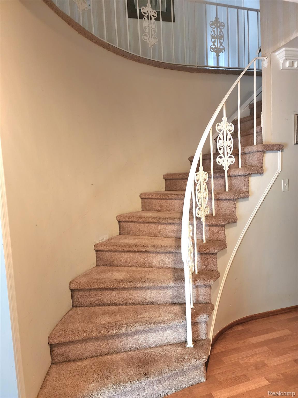 3333 Innsbrook Drive Rochester, MI 48309 - Photo 14 of 22 Curved staircase with carpeted treads and decorative metal railings
