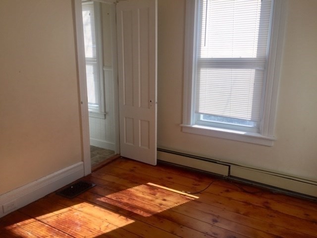51 May Street Worcester, MA 01610 - Photo 13 of 23 an empty room with wooden floor and windows