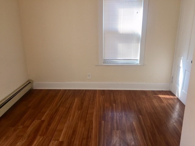 51 May Street Worcester, MA 01610 - Photo 14 of 23 a view of an empty room with wooden floor and a window