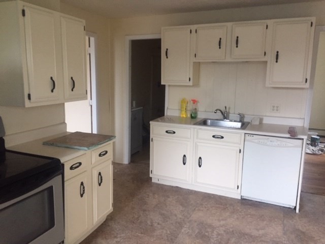 51 May Street Worcester, MA 01610 - Photo 15 of 23 a kitchen with white cabinets and white appliances