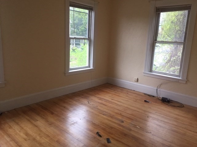 51 May Street Worcester, MA 01610 - Photo 18 of 23 a view of an empty room with wooden floor and a window
