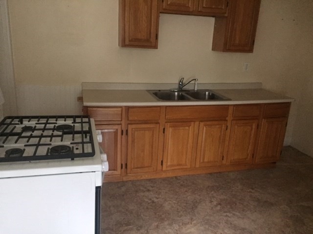 51 May Street Worcester, MA 01610 - Photo 19 of 23 a kitchen with a sink and cabinets