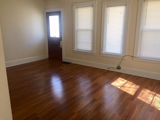 51 May Street Worcester, MA 01610 - Photo 9 of 23 an empty room with wooden floor and windows