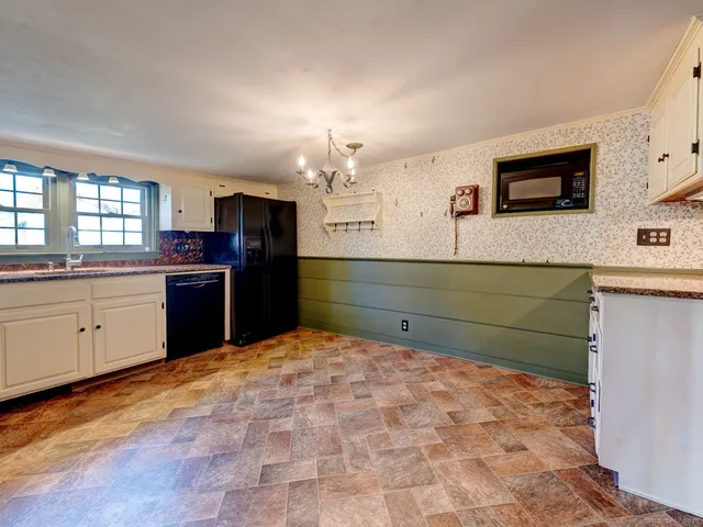 a kitchen with stainless steel appliances granite countertop a sink and cabinets
