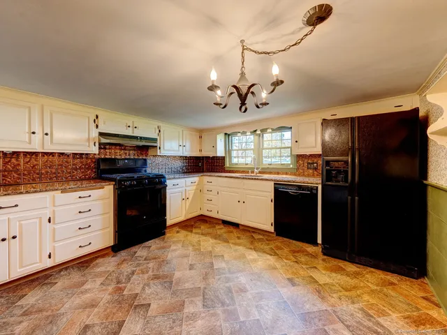 a kitchen with a refrigerator stove and sink