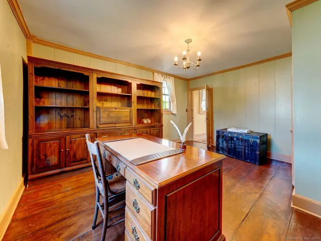 a view of a dining room with furniture and chandelier