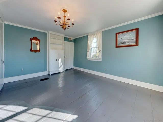 a view of a livingroom with wooden floor and a chandelier